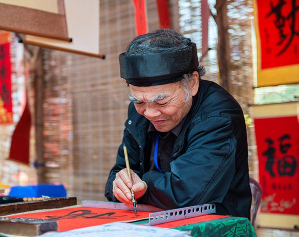 A master giving calligraphy letters on Lunar New Year