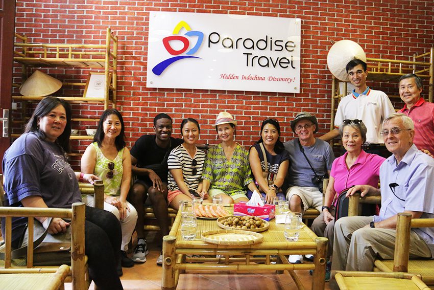 Alex and a family group at Paradise Travel's office
