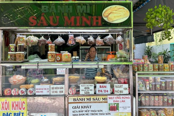 A vendor standing behind his banh mi stall in Ho Chi Minh City.