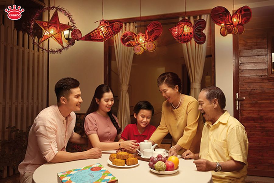 A joyful family celebrates the Mid-Autumn Festival with mooncakes, lanterns, and heartfelt togetherness across generations