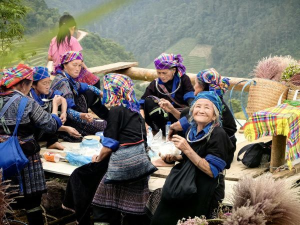 A group of Hmong women gather during a break