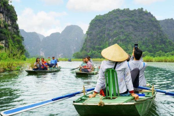 Boating through Tam Coc is magical during April in Vietnam’s serene countryside.