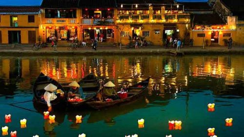 June in Vietnam lights up Thu Bon River with dazzling nighttime reflections.