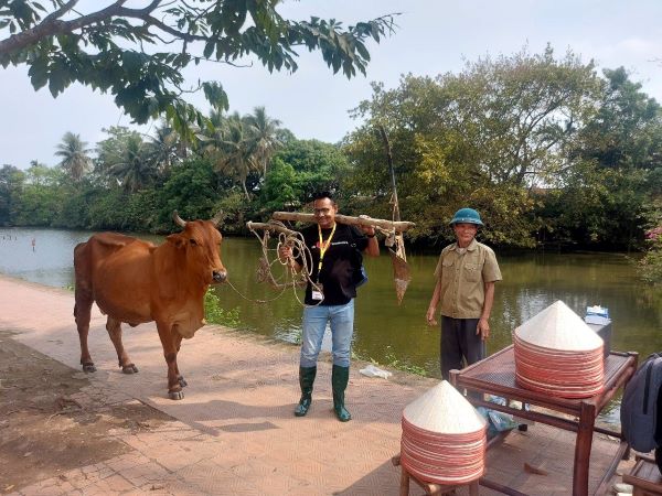 Tourists interact with livestock raised by Vietnamese farmers.