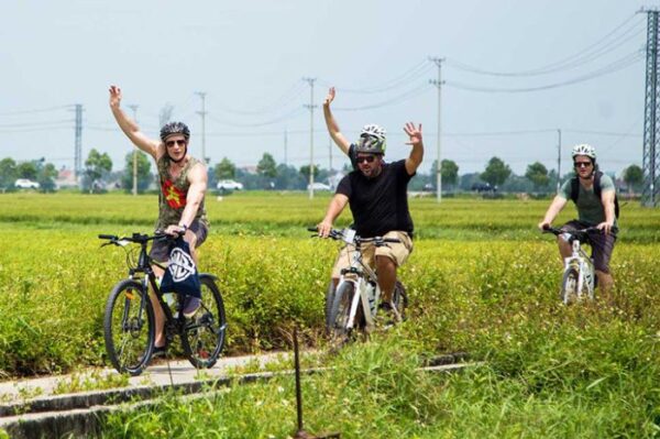 Cycling to Tra Que village, you will be immersed in green nature