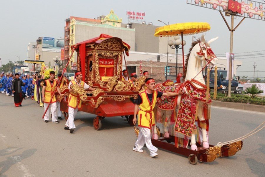 This vibrant scene depicts a ceremonial parade during the Do Temple Festival in Bac Ninh, where locals honor the Ly Dynasty emperors with elaborate costumes, symbolic offerings, and richly decorated floats.